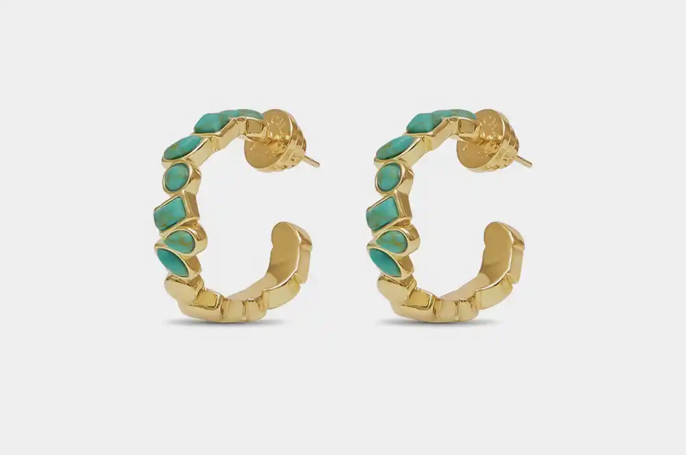 A close-up photo of an earring, shown before it has been fixed by our jewelry photo retouching service.