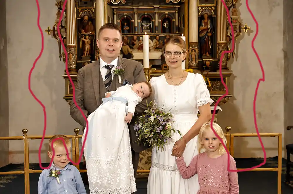 A family photo shown before the shadow removal service, with a dark shadow covering the furniture behind them.